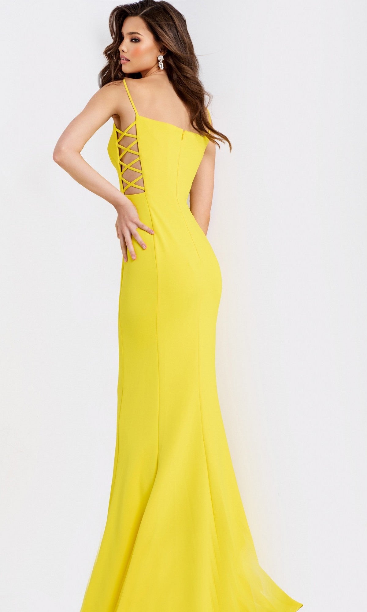 A woman models the Long Prom Dress: Jovani 43404, a floor-length bright yellow gown with lace-up back, against a plain white background.